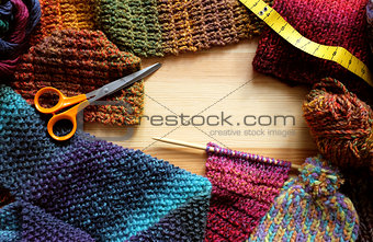 Border of knitting, wool, craft scissors and tape measure