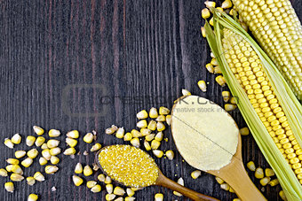 Flour and grits corn in spoons on dark wooden board