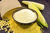 Flour corn in bowl with bag on board