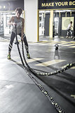 Girl does exercise with fitness rope in gym