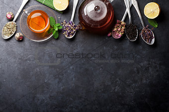 Tea cup and assortment of dry tea in spoons