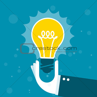 Innovation - hand holds shining light bulb