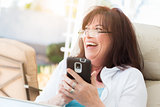 Attractive Middle Aged Woman Laughing While Using Her Smart Phon