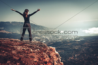 Woman on top of a mountain