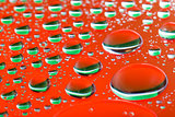 The Abstract orange red background with gradient color water drops on glass with reflection, big droplet, macro