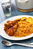jollof rice with chicken and fried plantain, west african cuisine