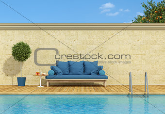 Blue sofa poolside