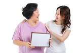Mother and daughter with blank board