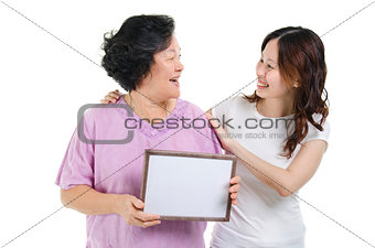 Mother and daughter with blank board