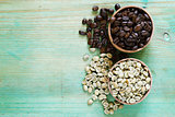 green and brown coffee beans on a wooden background