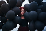 Beautiful girl walking with black balloons