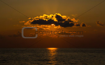 stunning orange sunset at sea bright sun create solar path on a quiet surface of water