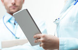 doctors thinking about exam's data with a tablet