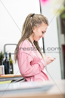 smilin woman sending messages with a phone