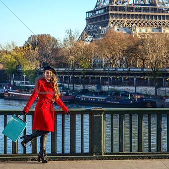 woman on embankment near Eiffel tower having fun time