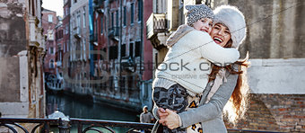 mother and daughter tourists in Venice, Italy in winter hugging