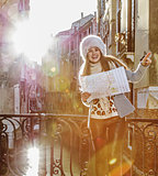 woman in Venice, Italy in winter holding map and pointing