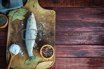 Fresh fish smelt spices for cooking on a kitchen board