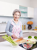 senior woman preparing meal in kitchen