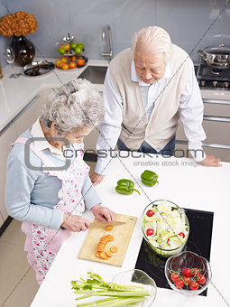 senior couple chatting in kitchen