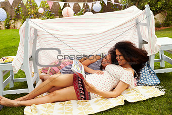 Mother And Daughter Playing In Home Made Garden Den