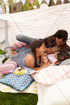 Father Playing With Daughters In Home Made Garden Den