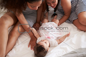 Mother And Daughter Playing With Baby At Home At Home