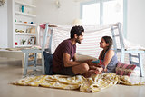 Father And Daughter Playing Indoors In Home Made Den