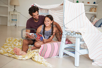 Father And Daughter Playing Indoors In Home Made Den