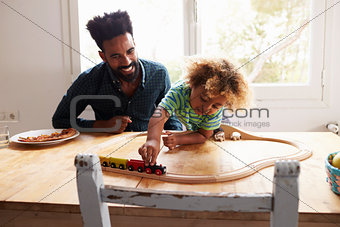 Father And Son Playing With Toy Train Set