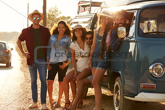 Friends in a camper van make a roadside stop, full length