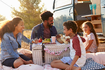 Family having a picnic beside their camper van