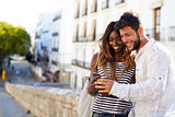 Young adult couple looking at smartphone, Ibiza, Spain