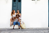 Three female friends sitting in a doorway, Ibiza