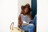 Young woman on sitting on steps reading a guidebook, close up