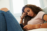 Teenage girl using smartphone at home, close up