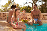 Family On Vacation Having Fun By Outdoor Pool