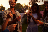 Group Of Friends With Sparklers Enjoying Outdoor Party