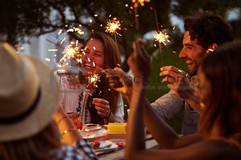 Friends With Sparklers Eating Food And Enjoying Party