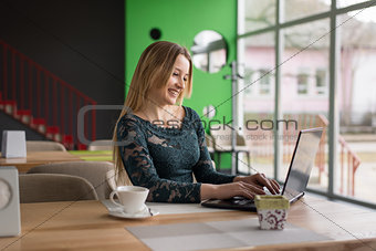 smiling girl sitting at laptop
