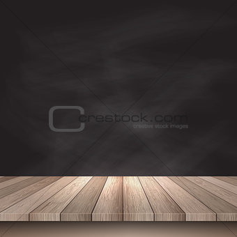 Wooden table against chalkboard background 