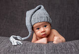 Beautiful newborn wearing a cute grey hat