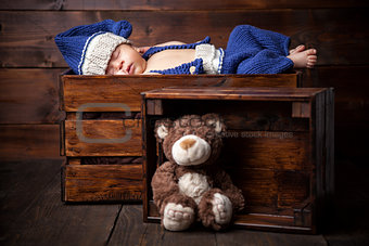 Sweet little newborn inside a wooden crate
