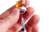 Hand holding syringe and medicine vial 