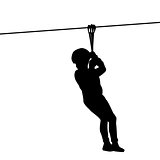 Silhouette of a kid playing with a tyrolean traverse