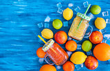 Citrus vitamin juice with fresh fruits around