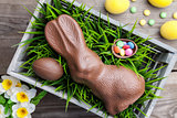Traditional Easter decoration background with flowers, bunnies and eggs 