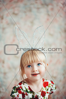 Portrait of a cute little girl with bunny ears.