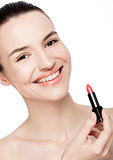 Beautiful model girl holding lipstick tube makeup