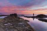 Lone man on the rocks at sunset at Treasure Island Beach